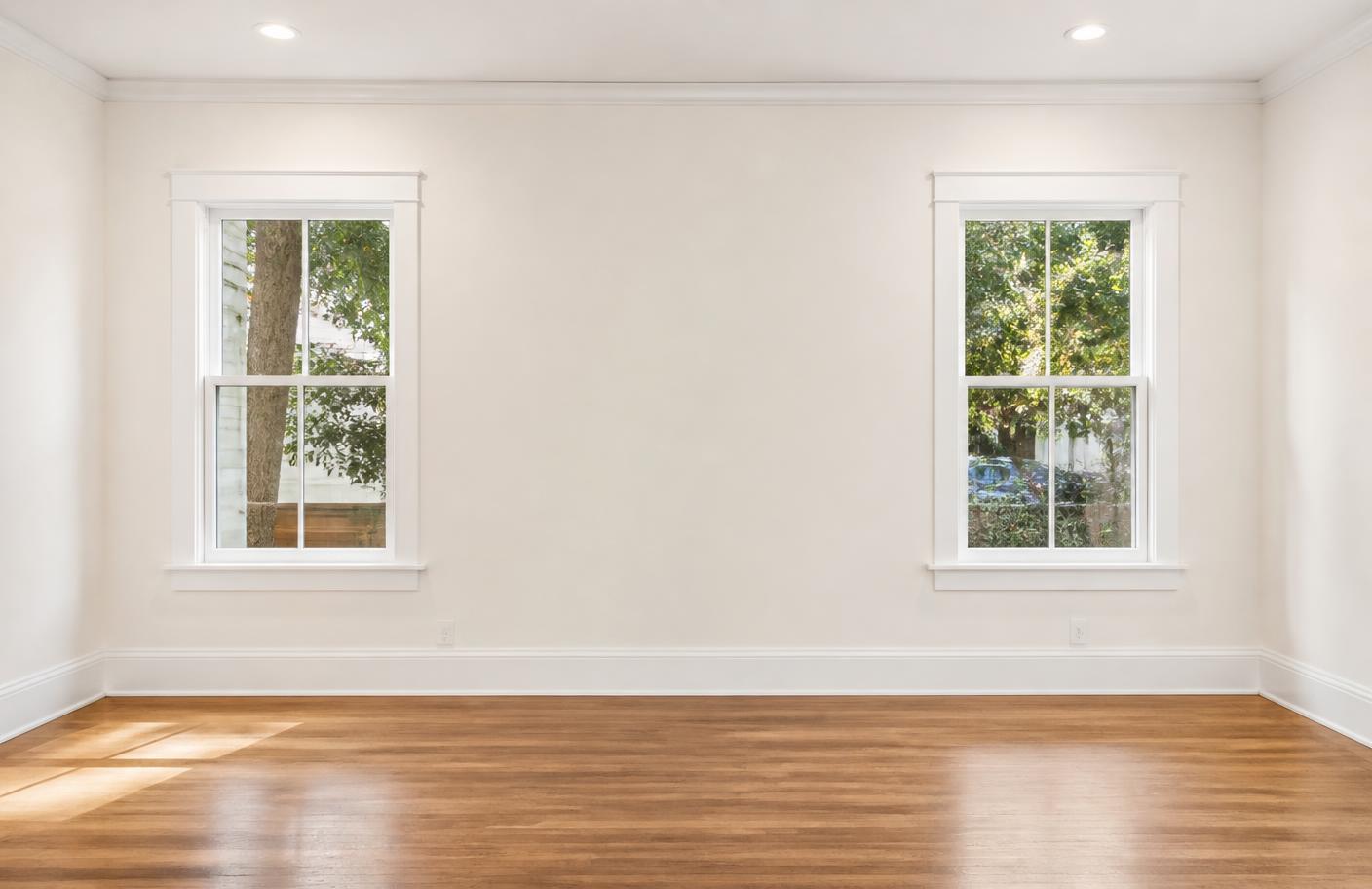 Living room after professional painting with flawless warm white walls and crisp trim